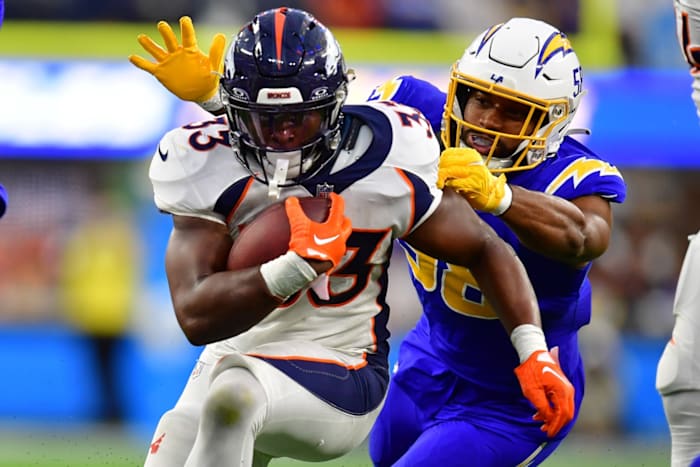 Dec 10, 2023; Inglewood, California, USA; Denver Broncos running back Javonte Williams (33) runs the ball against Los Angeles Chargers linebacker Justin Hollins (58) during the second half at SoFi Stadium. Mandatory Credit: Gary A. Vasquez-USA TODAY Sports